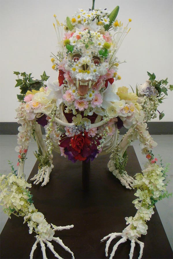 Flower-covered skeleton sculpture