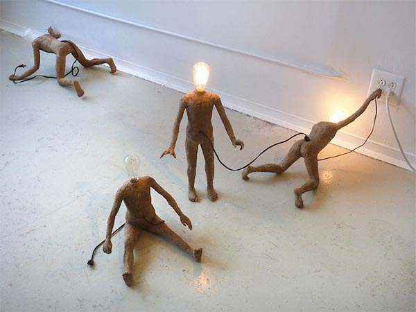 Miniature Lightbulb People Seek Life from Power Outlets