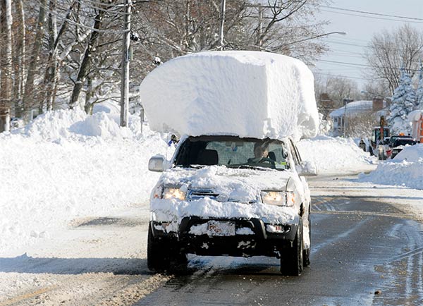 Vehicle with a large chunk of snow on its top