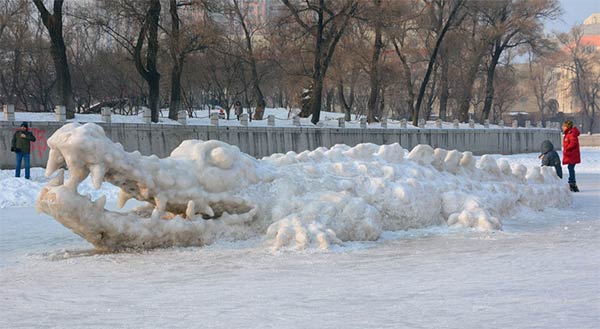 Giant crocodile sculpture made with snow