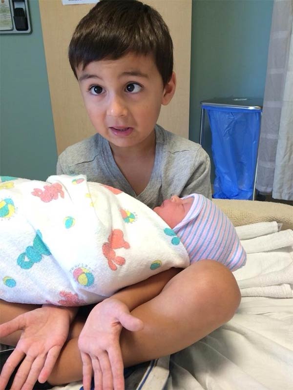 Boy Holding His Baby Sister For The First Time