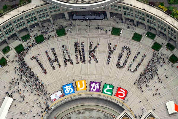 People Sitting In Formation To The Words THANK YOU