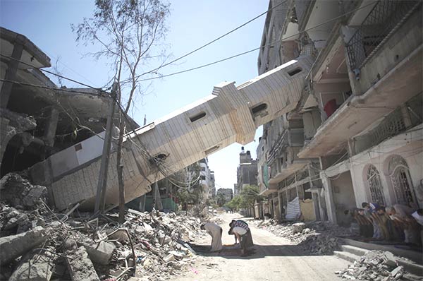 Palestinians Pray In The Shadow of Toppled Minaret