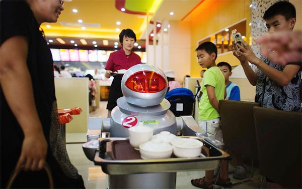 Customers in Restaurant Served By Robots