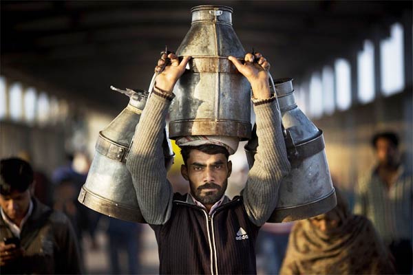 Indian Milkman Carries Milk Canisters
