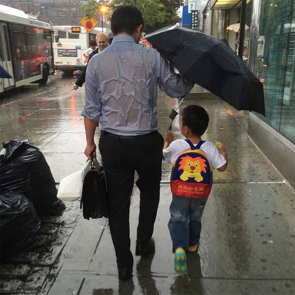 Soaked Dad Protecting His Schoolboy From Rain Shows What Parenting Is