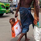 Father Carrying His Little Child in Bag