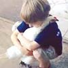 Little Boy Hugging A Chicken