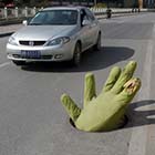 Giant Green Hand Emerges From Manhole