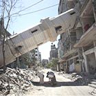 Palestinians Offering Prayer In The Shadow of Toppled Minaret